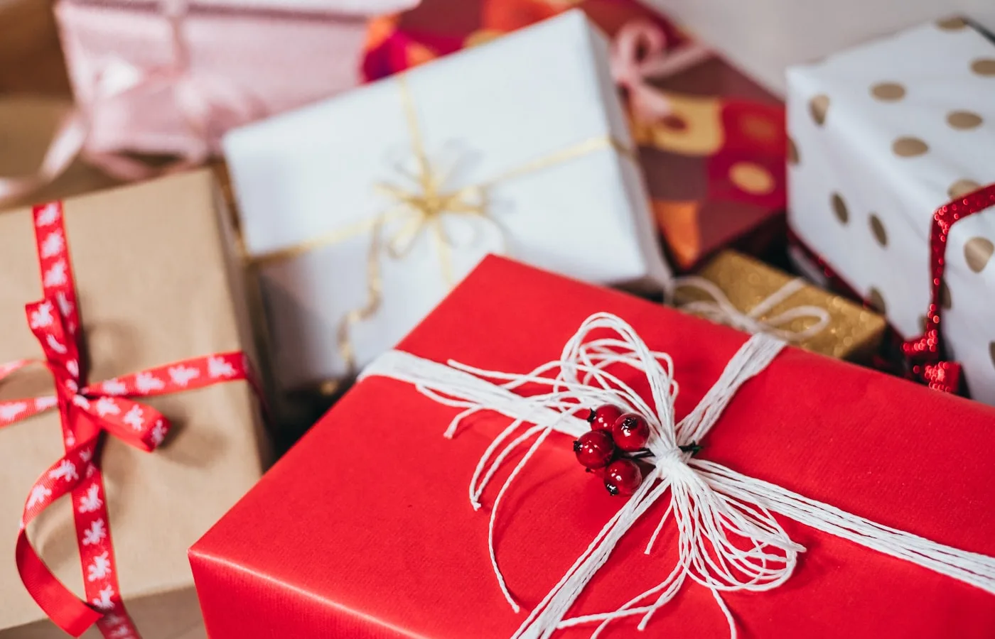 Wrapped handmade gifts tied with ribbon on a wooden table