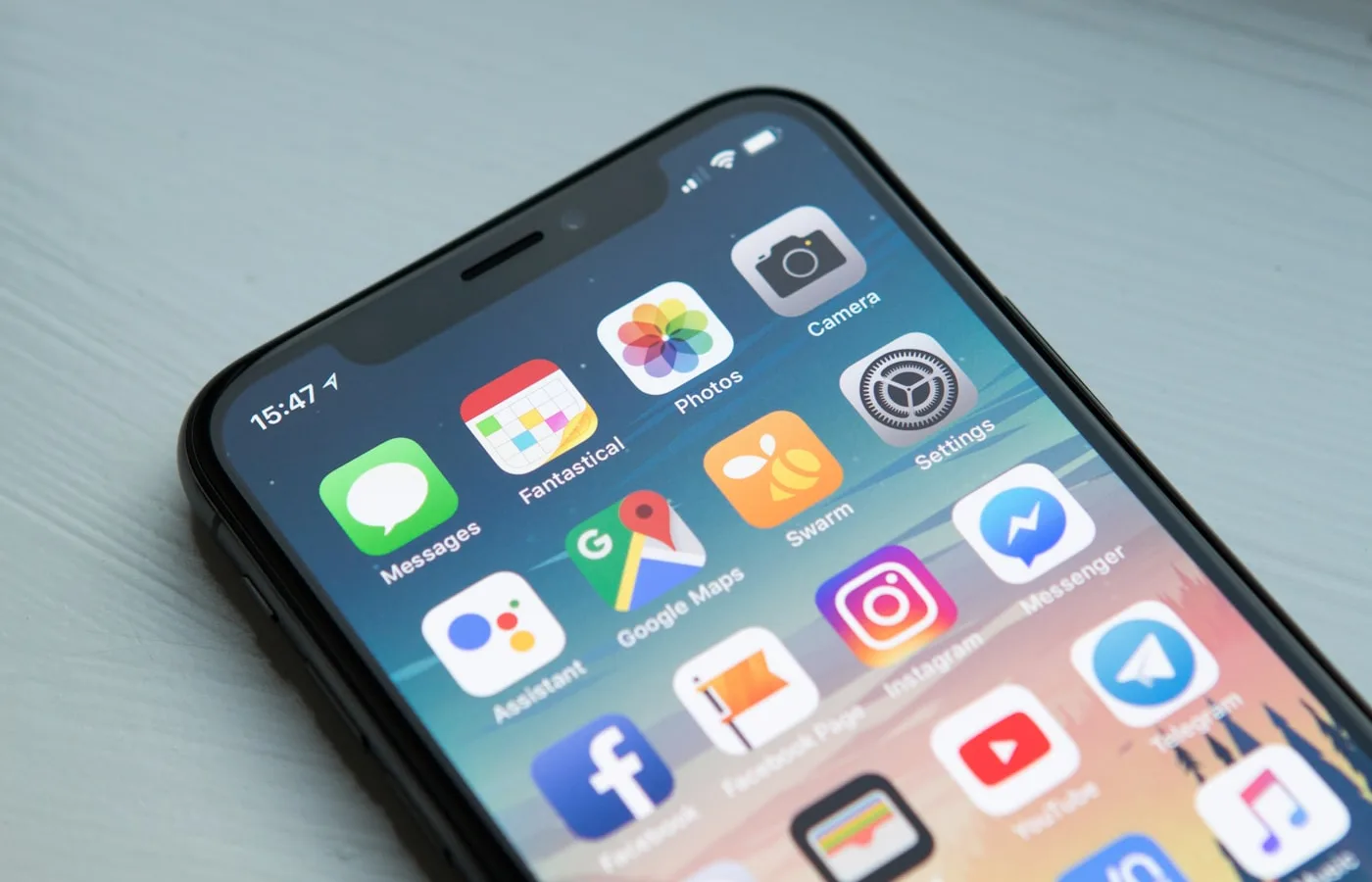 Hands holding a phone with a marketplace app on screen