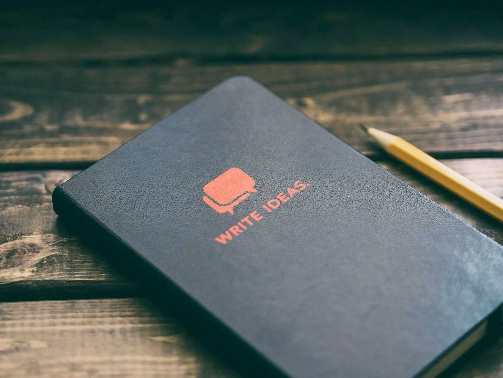 Hands writing in a notebook