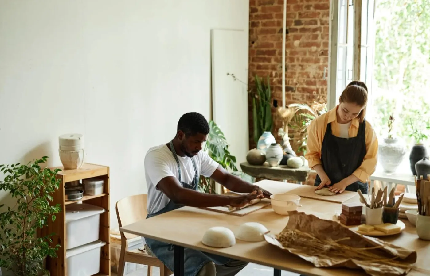 Artisans at work in a sunlit craft workshop